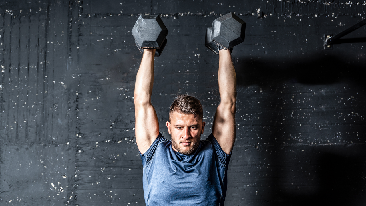 man doing dumbbell thrusters