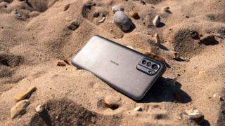 Nokia X30 5G lying in sand in a desert