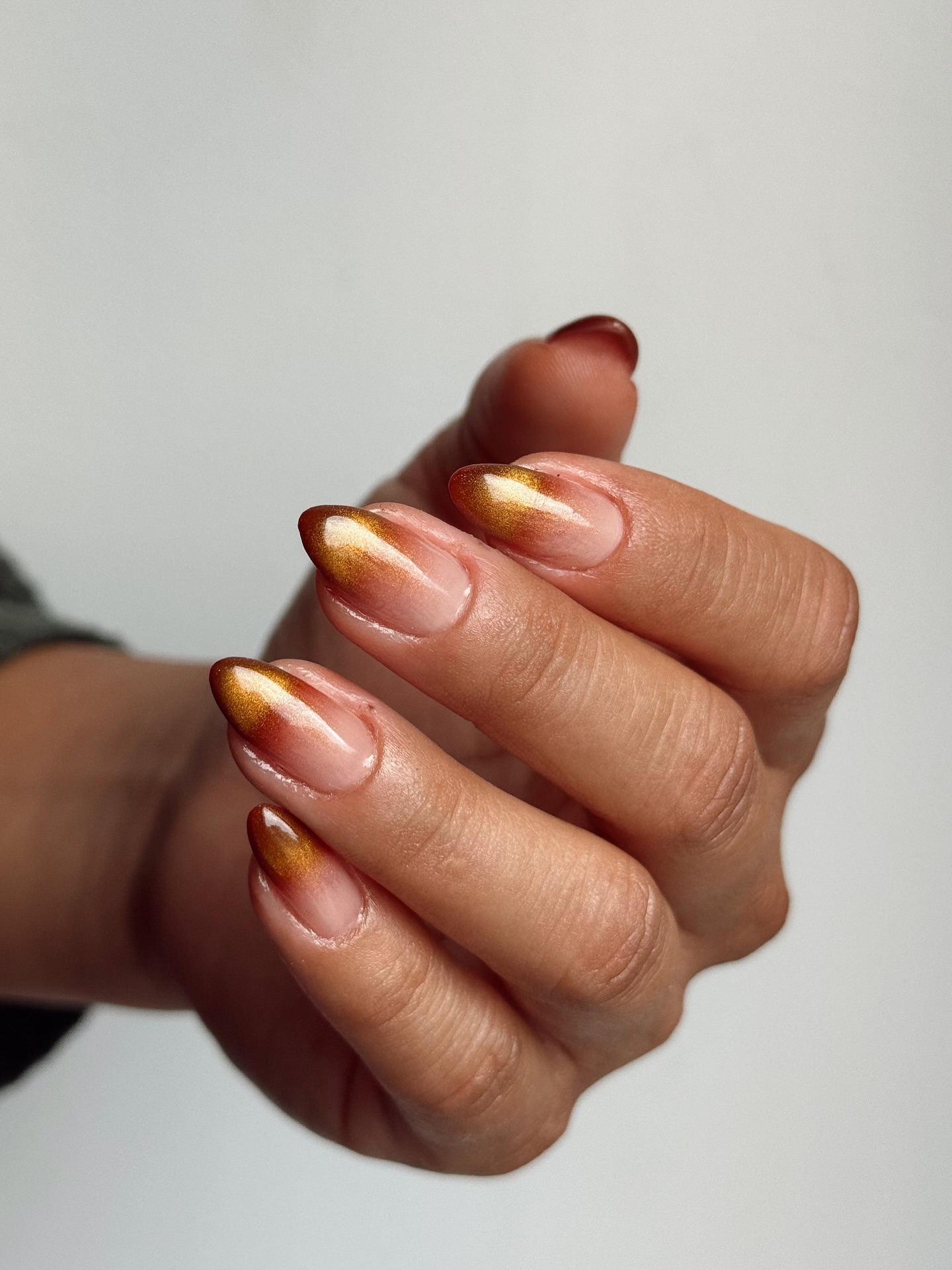 A cinnamon-coloured blended French tip manicure