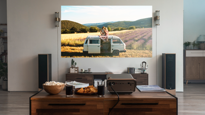 A projector displaying a travel scene in a living room