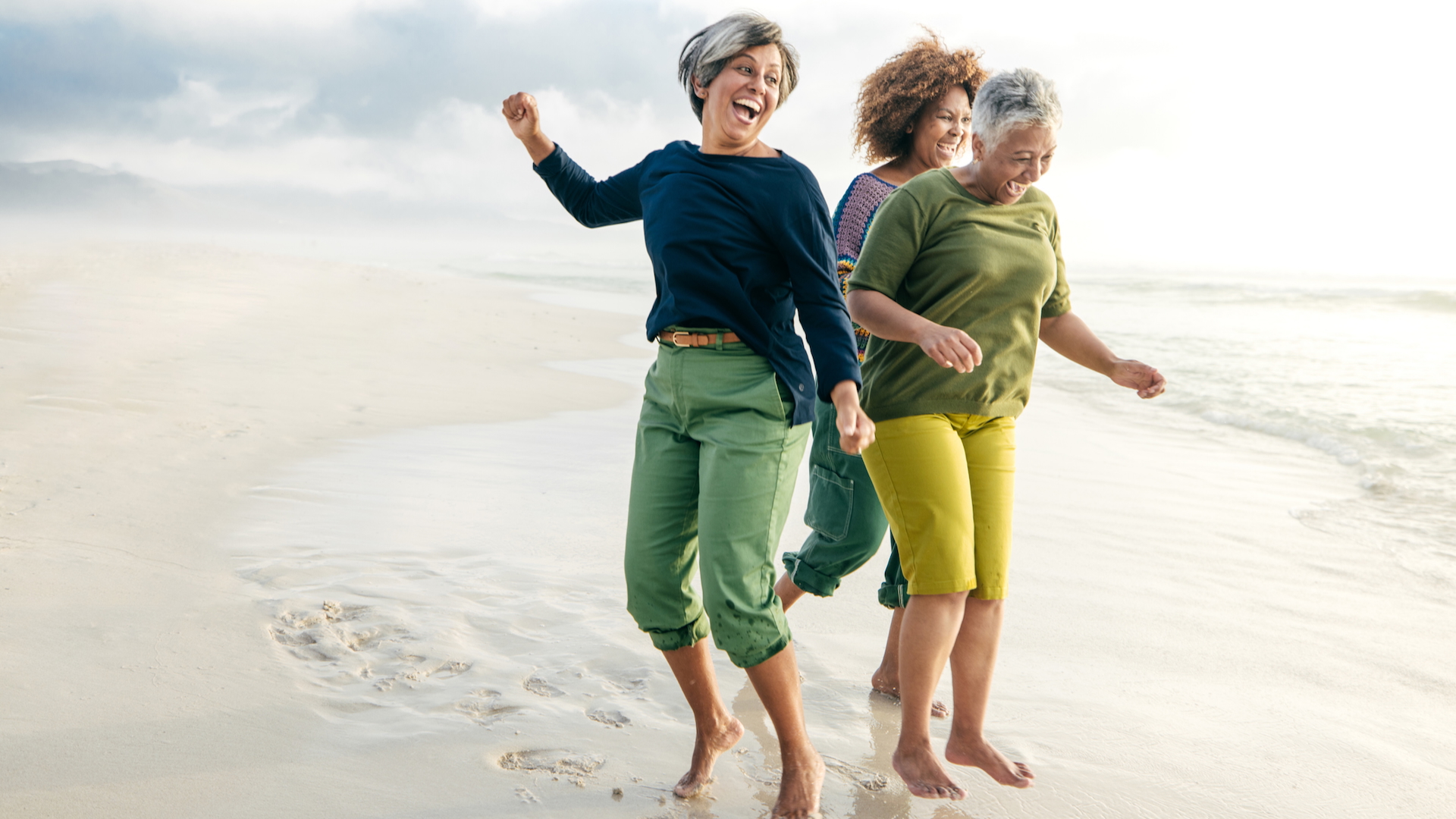A group of three women smiling and laughing together