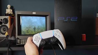 Hand holding PS5 DualSense in front of original PS2 connected to Sony PVM CRT TV on right with 8Bitdo Retro Receiver connected and Silent Hill 2 gameplay on screen.