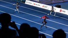 Lightning streaks down the track during its record-breaking 100-meter run during the opening ceremony of 2nd World Humanoid Robot Games in Beijing