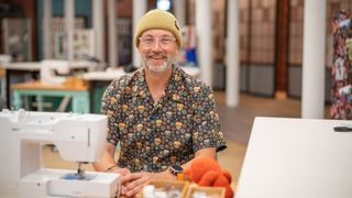 Tony R in a yellow beanie and patterned shirt for The Great British Sewing Bee 2023