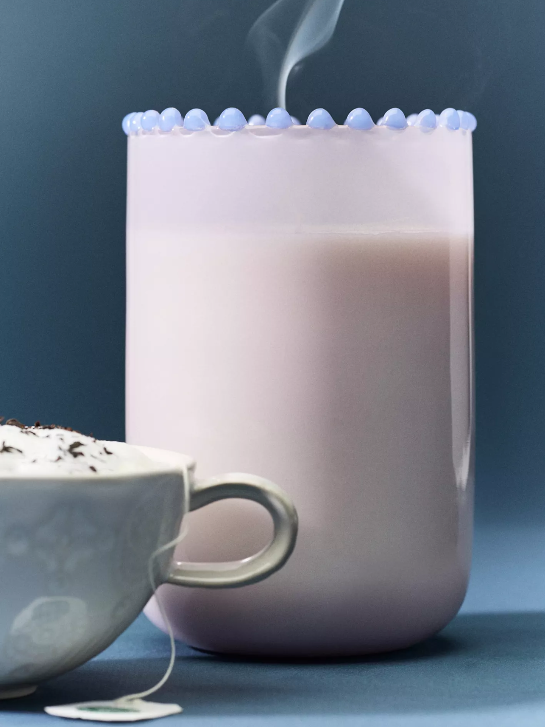 A purple dotted rimmed glass candle with an earl gray scent