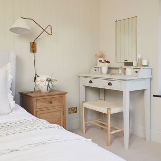neutral bedroom with dressing table and stool