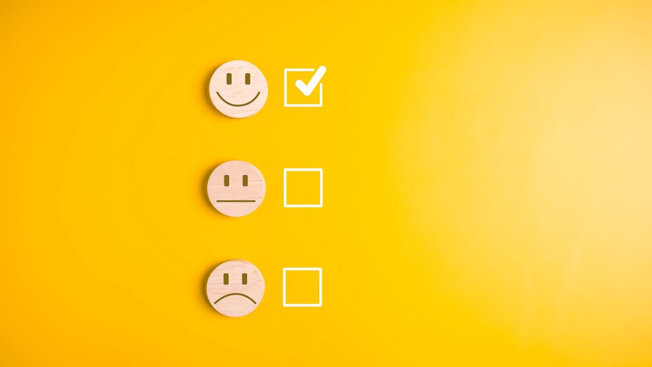 Happy, neutral and sad faces are lined up with check boxes next to them. The happy face box is checked.