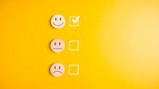 Happy, neutral and sad faces are lined up with check boxes next to them. The happy face box is checked.