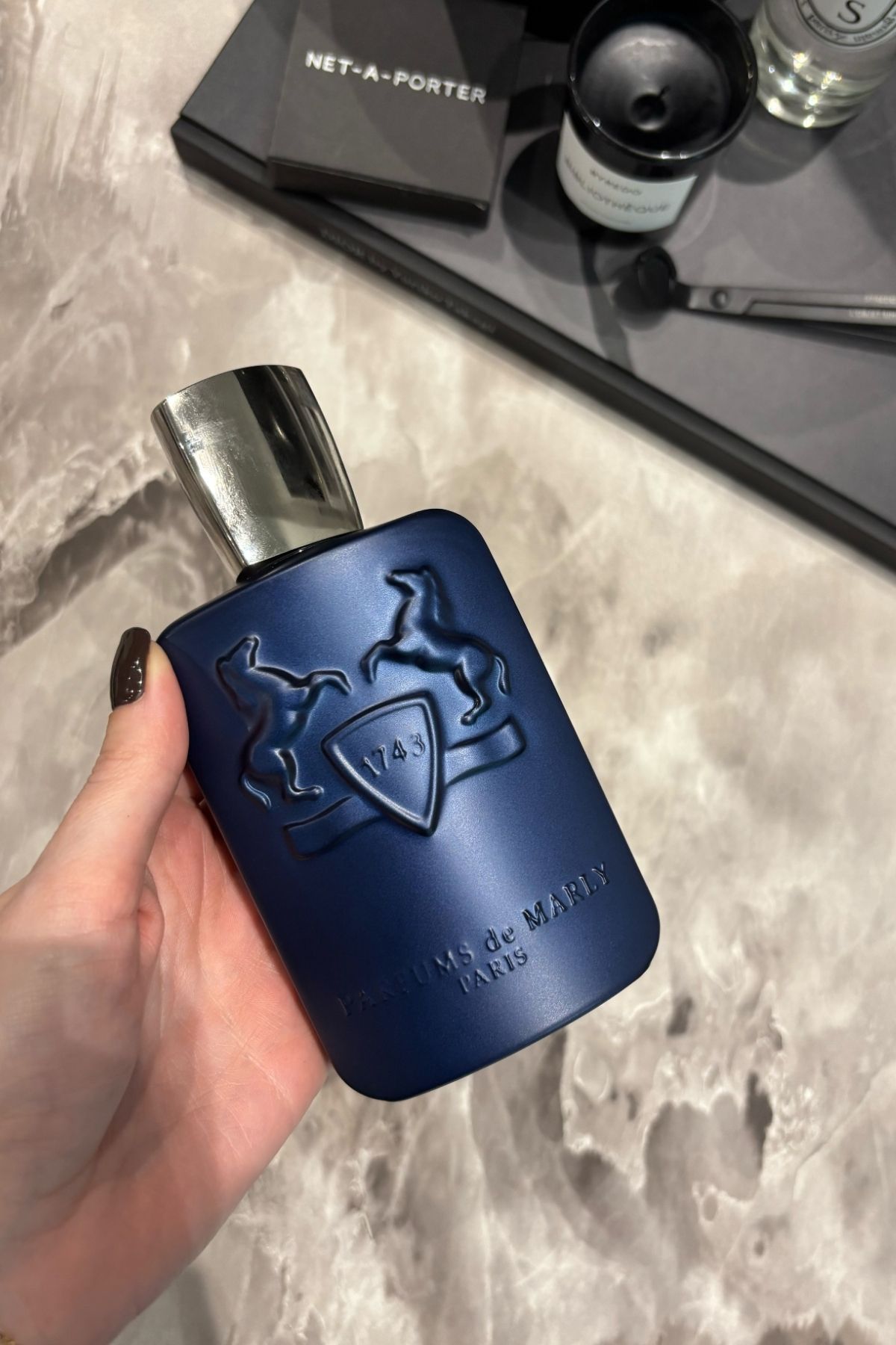 Deputy beauty editor Grace Lindsay holding a bottle of Parfums de Marly Layton