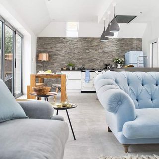 living room with blue sofaset and rug on floor