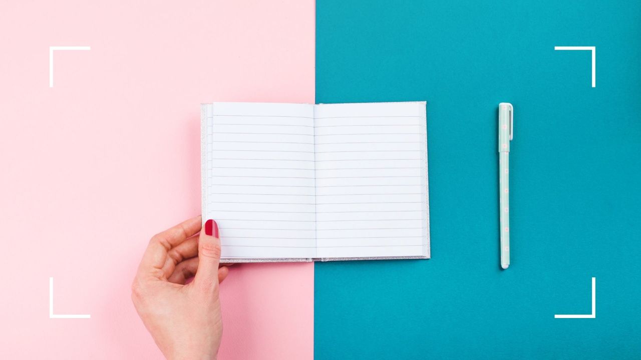 Goal planner on a colored background with a pen