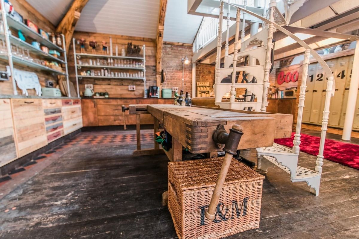 The kitchen shows oak worktops and a kitchen island within the open plan living room