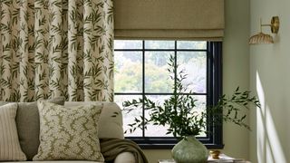 living room with patterned curtains and neutral roller blind