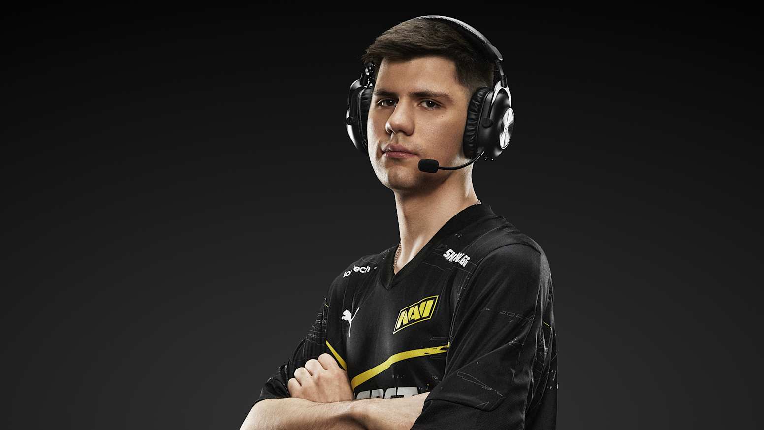 An esports pro wearing a Logitech Pro X 2 Wireless headset against a black background.
