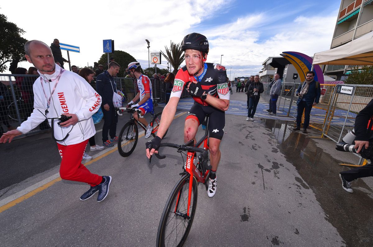 Stefan Kung holds his dislocated shoulder after the finish of stage 2