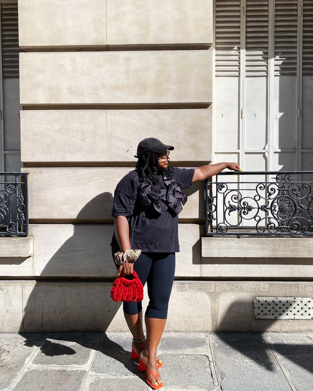 Dominique in black leggings and t-shirt with red bag