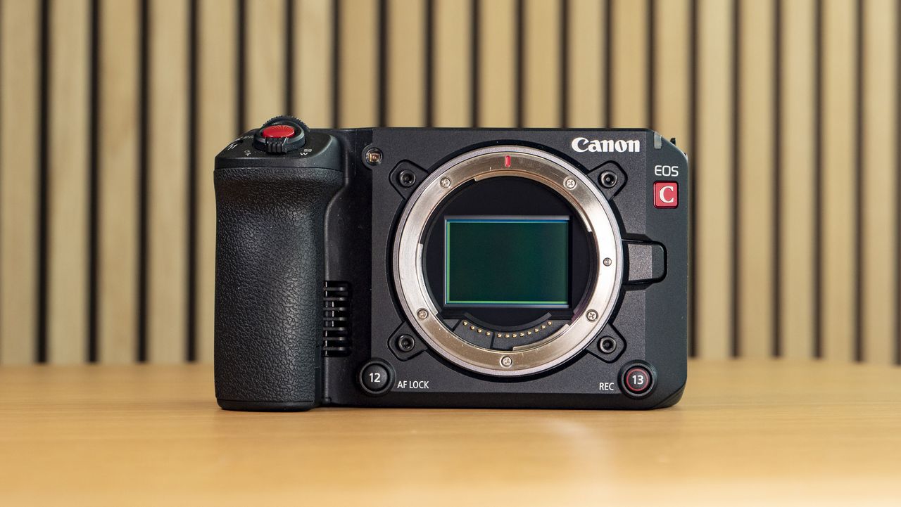 Canon EOS C50 on a wooden surface, no lens attached