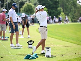 Kurt Kitayama hitting golf balls on the driving range on the PGA Tour