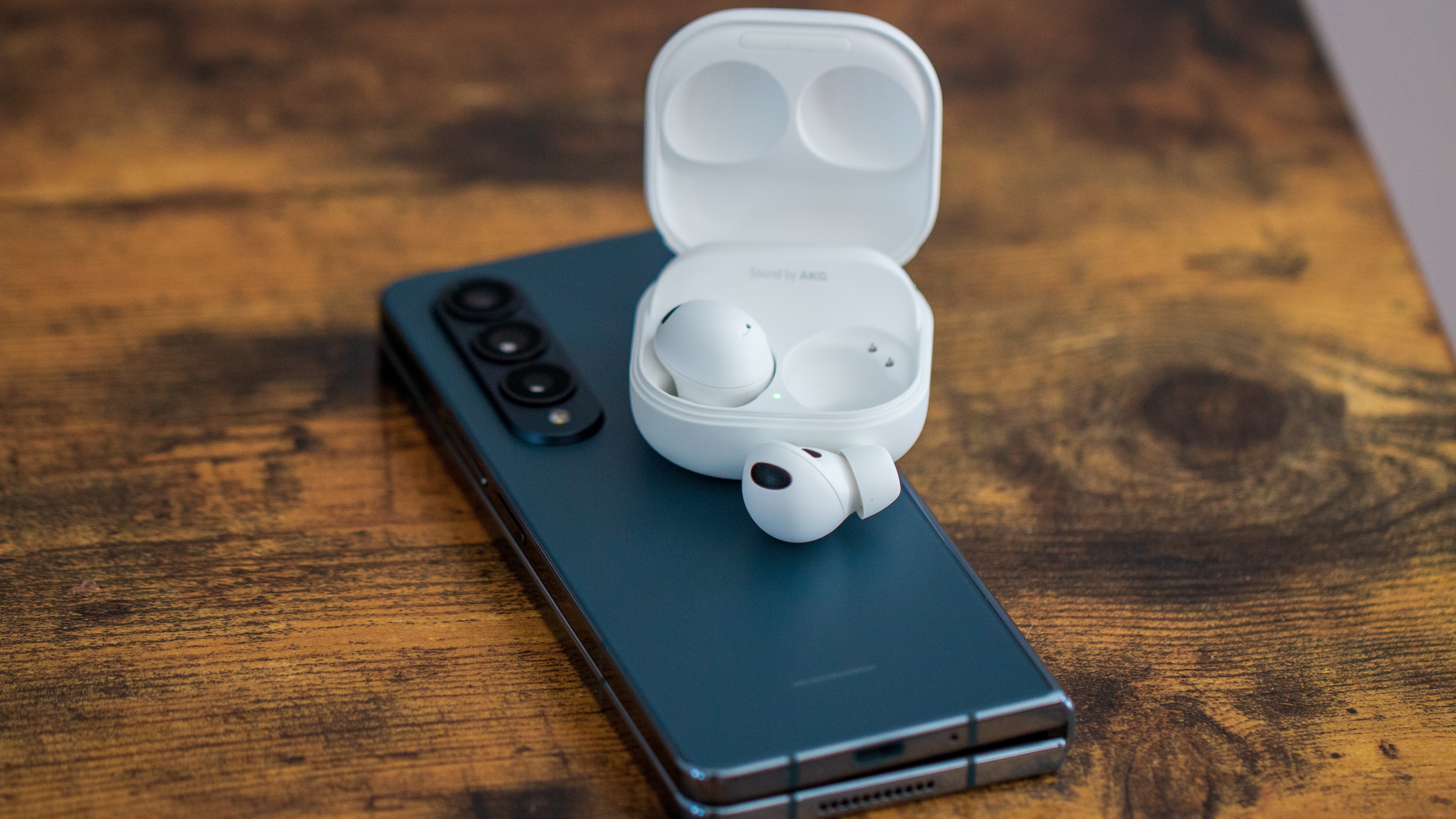 Samsung Galaxy Buds 2 Pro close-up with case open on top of Galaxy Z Fold 4