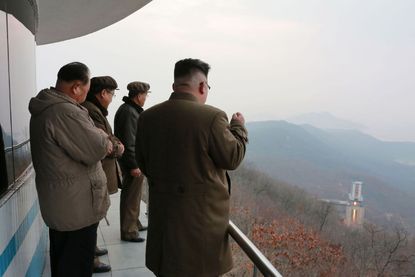 North Korean leader Kim Jong Un watches a rocket engine test 