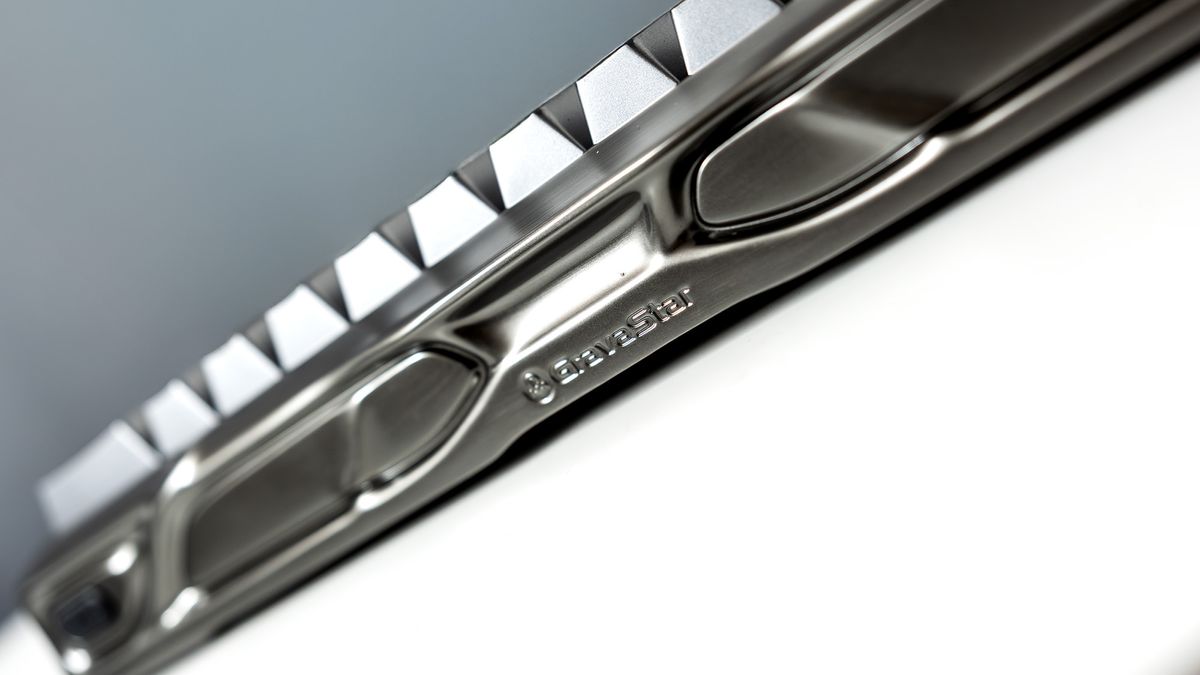 A Gravastar Mercury V60 Pro gaming keyboard with a shiny aluminium shell on a white desk.