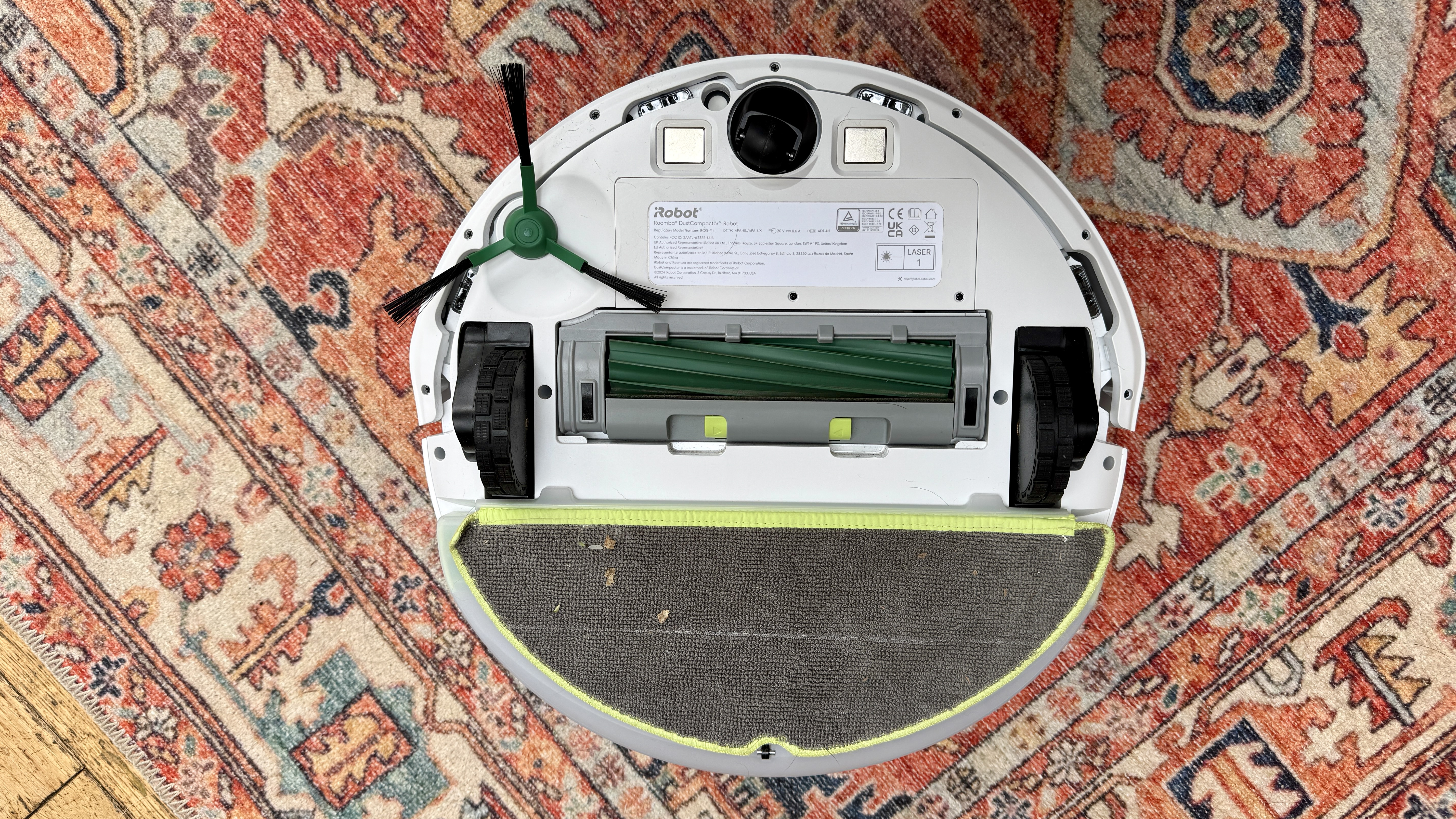 iRobot Roomba 205 DustCompactor Combo robot vacuum flipped over to show underside