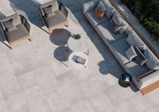 grey porcelain patio paving with modern garden furniture
