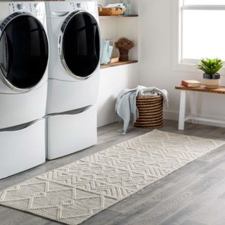 A cream textured carpet runner in a laundry room