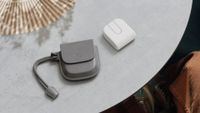 Logitech Mobi Fold next to its pouch on a table