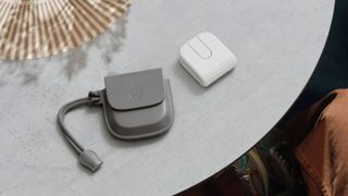 Logitech Mobi Fold next to its pouch on a table