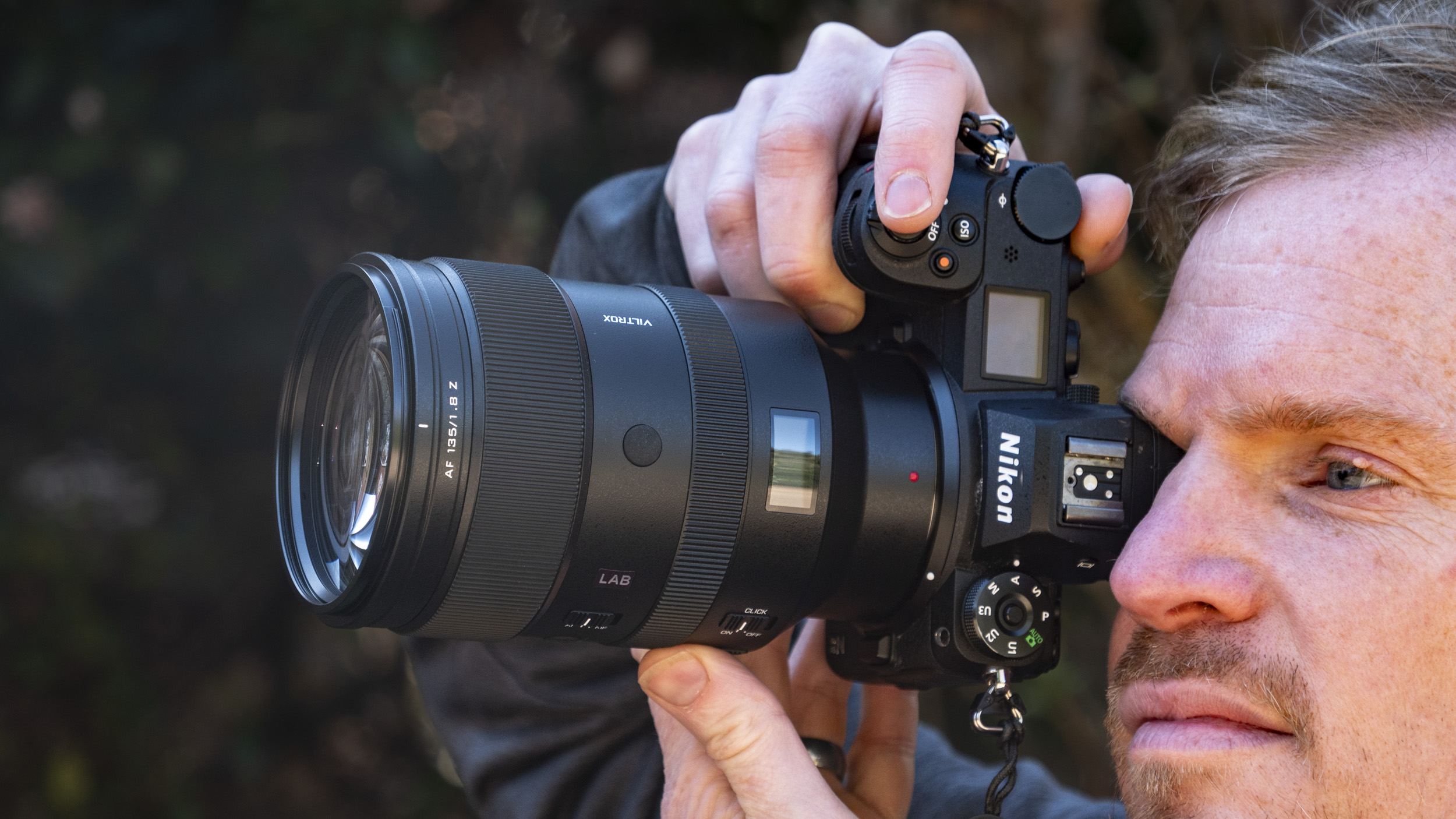 Viltrox 135mm F1.8 Lab lens for Nikon Z-mount, in the hand, attached to a Nikon Z6 II