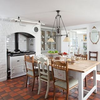 white kitchen area with cookpot and dining table
