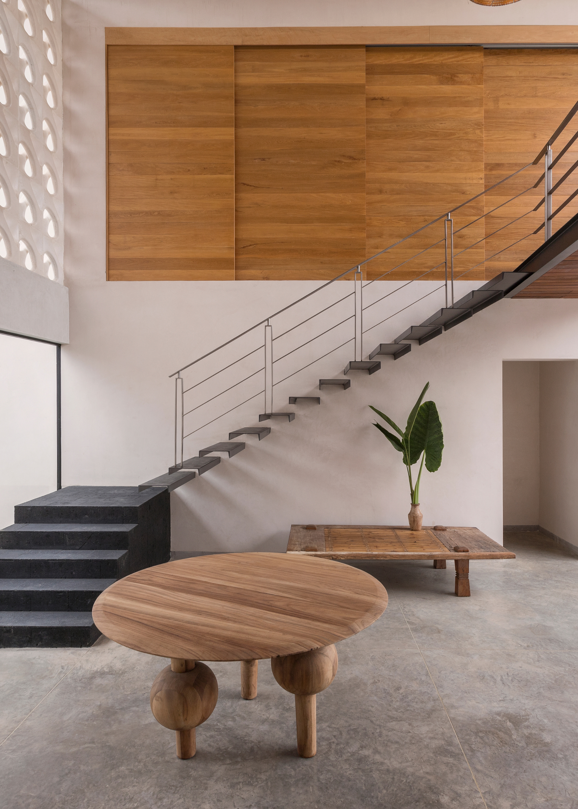 Concrete staircase and feature wooden table in a concrete and wood entryway