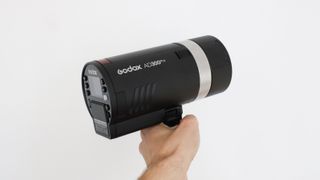 Godox Ad300Pro flash held in a hand