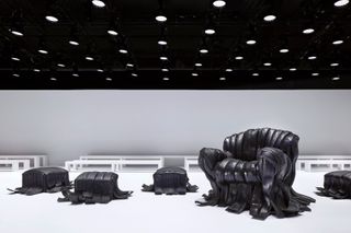 Acne Studios A/W 2024 runway set with Villu Jaanisoo’s rubber tire sofas