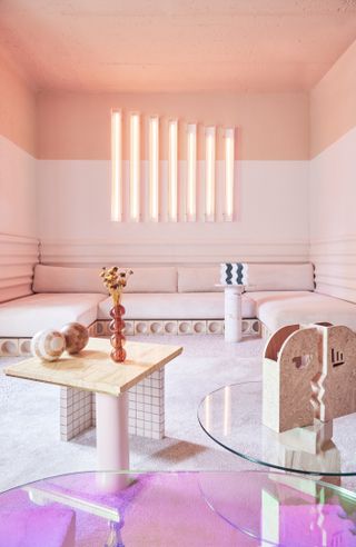A living room with light and dark pink walls