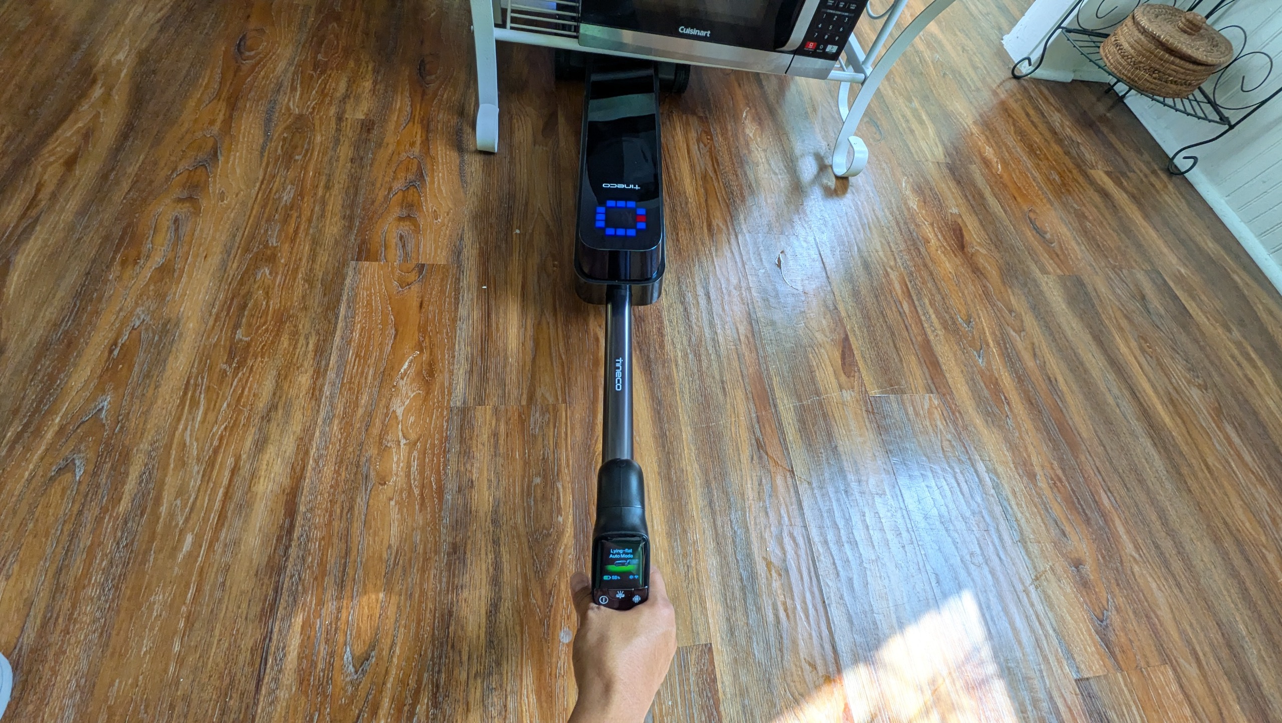 Tineco Floor ONE Station S9 Scientist Pro wet and dry vacuum cleaner vacuuming under low furniture