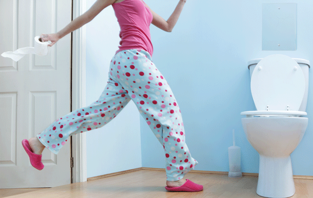Woman rushing to the toilet