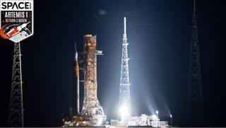 huge artemis 1 rocket on the launch pad at night