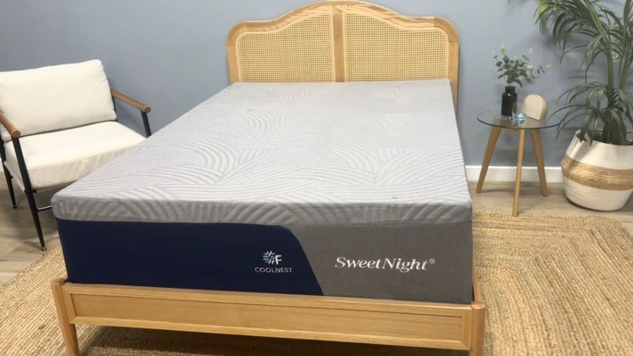 The SweetNight CoolNest Mattress on a wooden bed frame in a neutral-colored modern bedroom setting.
