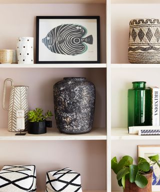 pink shelving with decorative vases and artwork