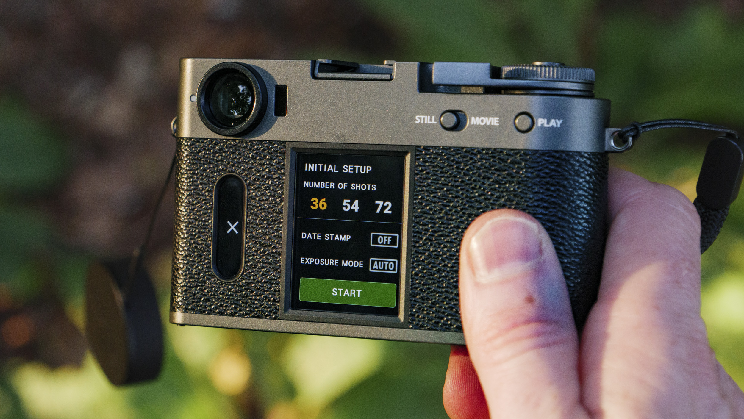 Fujifilm X half camera in the hand at golden hour