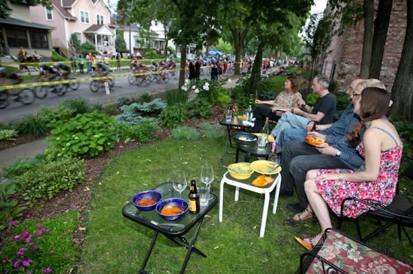 Fans enjoying wine, snacks and a bike race.