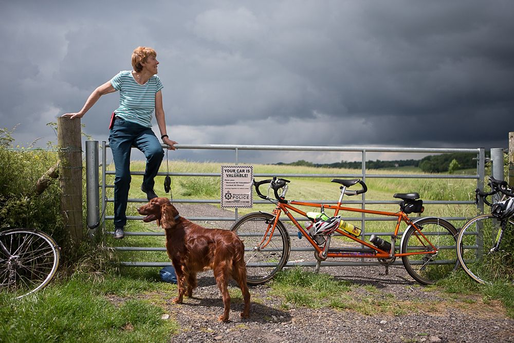 A spectator and her dog awaits the peloton during the Aviva Women's Tour 2016 - Stage 2