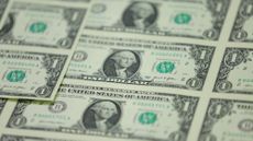 A sheet of $1 bills are seen at a printing facility.