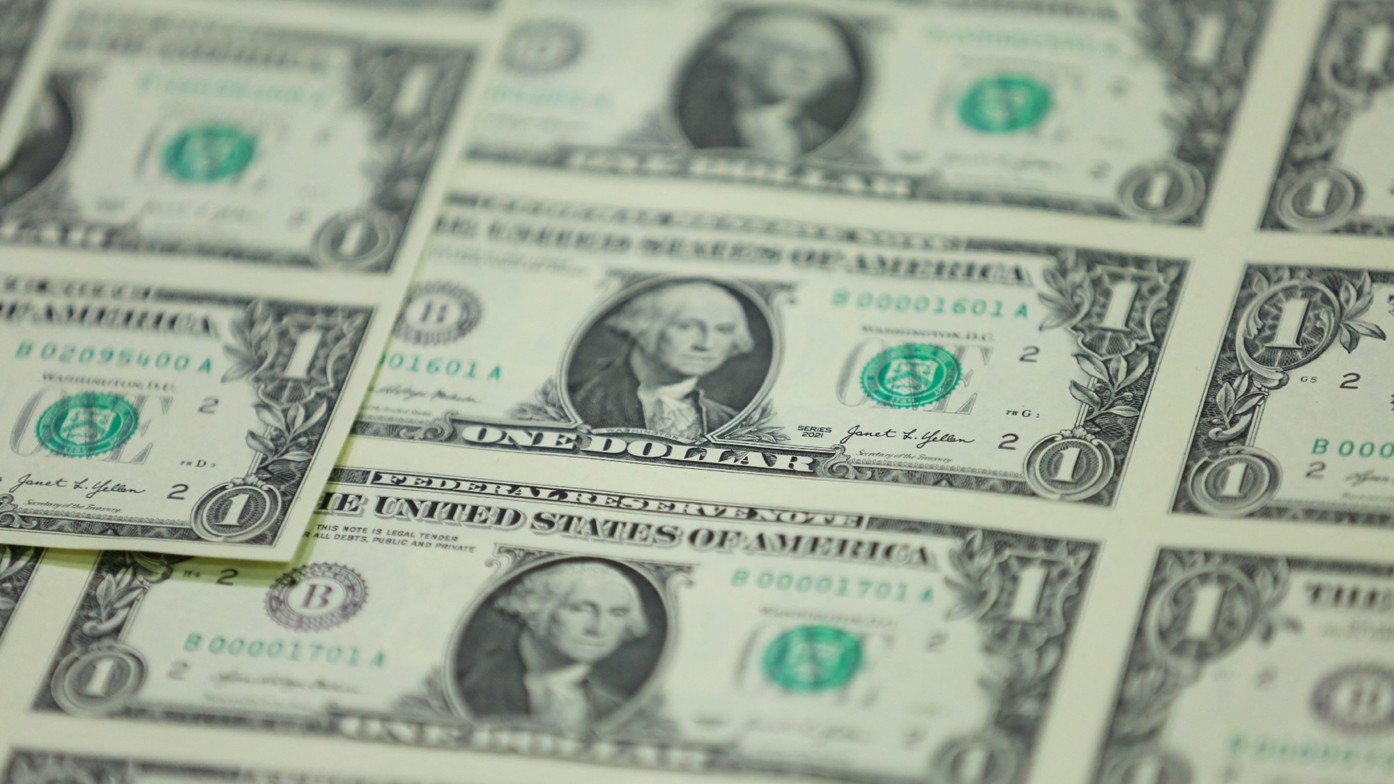 A sheet of $1 bills are seen at a printing facility. 