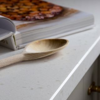 white marble work top and wooden spoon and book