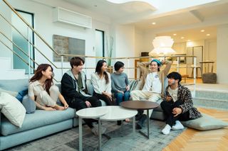 The cast of Terrace House Tokyo 2019-2020 sitting on a couch together