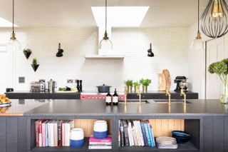 big kitchen island with built-in shelving with books and vases