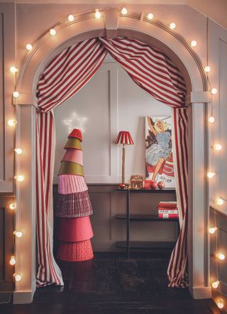 An arch with circus theme decorating and lights